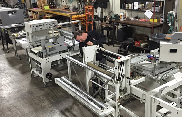 Service tech working on packaging machine